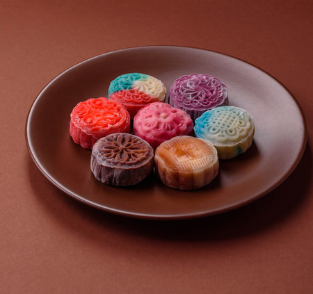 Chinese mooncake is an Asian sweet dessert with a coating of rice dough and fruit filling. Asian mooncake as a background for your designの写真素材