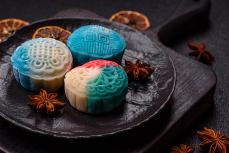 Chinese mooncake is an Asian sweet dessert with a coating of rice dough and fruit filling. Asian mooncake as a background for your designの写真素材