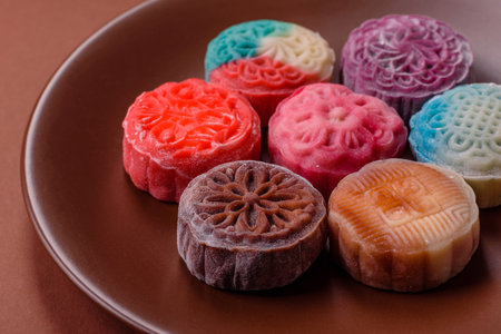 Chinese mooncake is an Asian sweet dessert with a coating of rice dough and fruit filling. Asian mooncake as a background for your designの写真素材