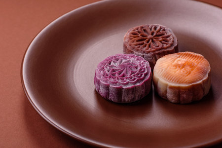 Chinese mooncake is an Asian sweet dessert with a coating of rice dough and fruit filling. Asian mooncake as a background for your designの写真素材