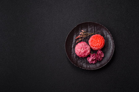 Chinese mooncake is an Asian sweet dessert with a coating of rice dough and fruit filling. Asian...