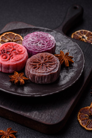 Chinese mooncake is an Asian sweet dessert with a coating of rice dough and fruit filling. Asian mooncake as a background for your designの写真素材