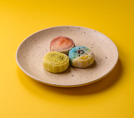 Chinese mooncake is an Asian sweet dessert with a coating of rice dough and fruit filling. Asian mooncake as a background for your designの写真素材