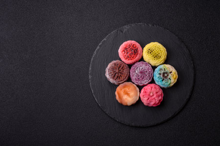 Chinese mooncake is an Asian sweet dessert with a coating of rice dough and fruit filling. Asian mooncake as a background for your designの写真素材