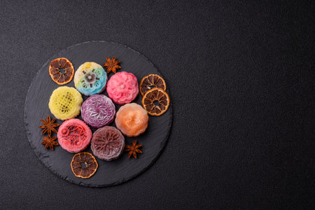 Chinese mooncake is an Asian sweet dessert with a coating of rice dough and fruit filling. Asian mooncake as a background for your designの写真素材