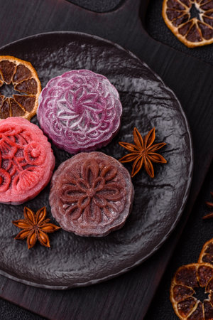 Chinese mooncake is an Asian sweet dessert with a coating of rice dough and fruit filling. Asian mooncake as a background for your designの写真素材