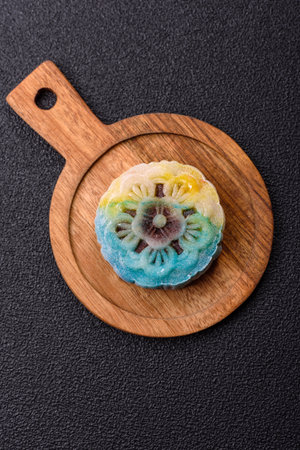 Chinese mooncake is an Asian sweet dessert with a coating of rice dough and fruit filling. Asian...