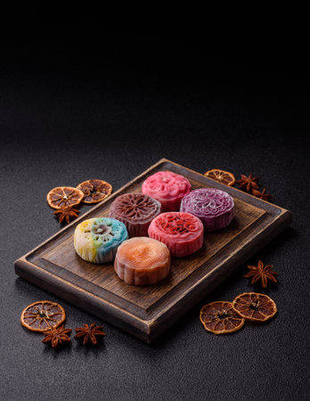 Chinese mooncake is an Asian sweet dessert with a coating of rice dough and fruit filling. Asian mooncake as a background for your designの写真素材