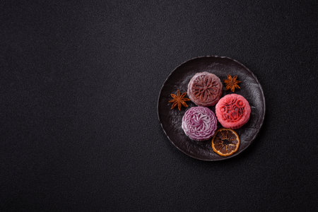 Chinese mooncake is an Asian sweet dessert with a coating of rice dough and fruit filling. Asian...