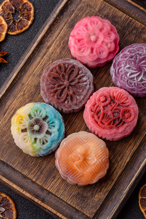 Chinese mooncake is an Asian sweet dessert with a coating of rice dough and fruit filling. Asian mooncake as a background for your designの写真素材