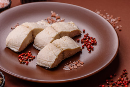 White fish fillets, seafood cooked with salt and spices. Fish fillets on a ceramic plateの写真素材
