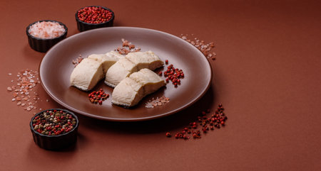 White fish fillets, seafood cooked with salt and spices. Fish fillets on a ceramic plateの写真素材