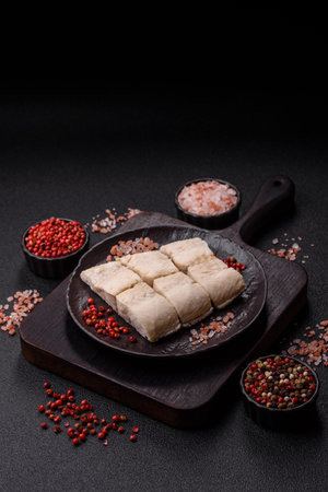 White fish fillets, seafood cooked with salt and spices. Fish fillets on a ceramic plateの写真素材