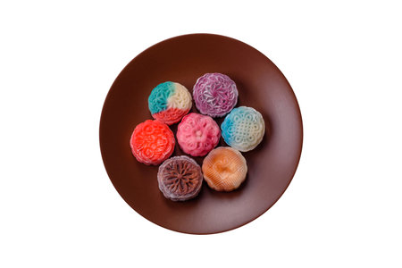 Chinese mooncake is an Asian sweet dessert with a coating of rice dough and fruit filling. Asian...