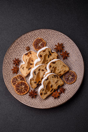 Christmas stollen, a German sweet cake with marzipan fruit and candied fruit. Winter Christmas stollen for the festive tableの写真素材