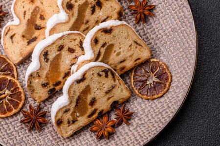 Christmas stollen, a German sweet cake with marzipan fruit and candied fruit. Winter Christmas stollen for the festive tableの写真素材