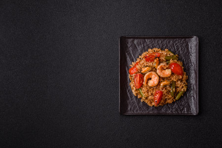 Rice and prawns or paella, a meal with seafood and vegetables. Cooked rice with shrimp, Asian or...