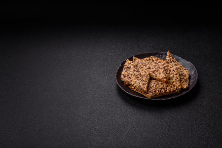 Crispbread, thin bread with seeds and grains, a baked cracker. Crispbread with pumpkin seeds and flax and sesame seedsの写真素材