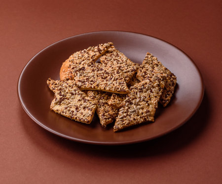 Crispbread, thin bread with seeds and grains, a baked cracker. Crispbread with pumpkin seeds and flax and sesame seedsの写真素材