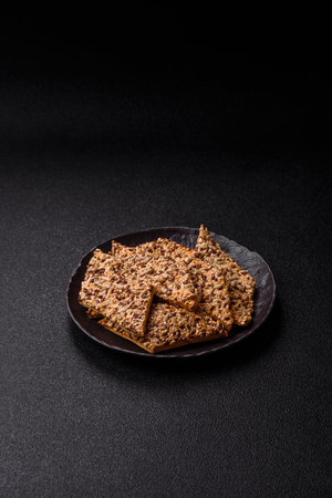 Crispbread, thin bread with seeds and grains, a baked cracker. Crispbread with pumpkin seeds and flax and sesame seedsの写真素材