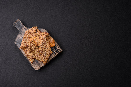 Crispbread, thin bread with seeds and grains, a baked cracker. Crispbread with pumpkin seeds and flax and sesame seedsの写真素材