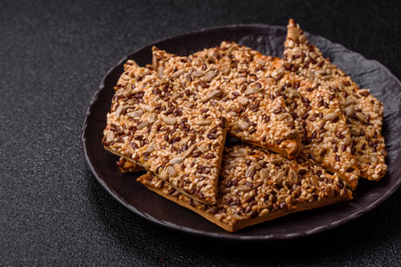 Crispbread, thin bread with seeds and grains, a baked cracker. Crispbread with pumpkin seeds and flax and sesame seedsの写真素材