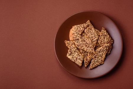 Crispbread, thin bread with seeds and grains, a baked cracker. Crispbread with pumpkin seeds and flax and sesame seedsの写真素材