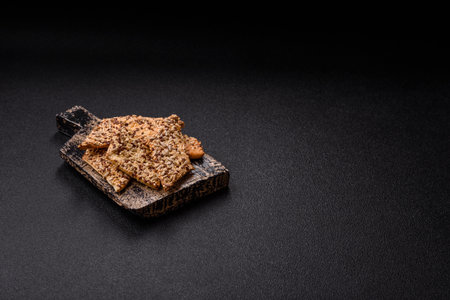 Crispbread, thin bread with seeds and grains, a baked cracker. Crispbread with pumpkin seeds and flax and sesame seedsの写真素材