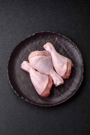 Raw chicken legs, fresh uncooked poultry meat. Chicken or turkey legs with salt and spicesの写真素材