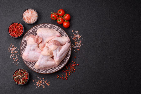 Raw chicken wings, fresh uncooked poultry meat. Chicken or turkey wings with salt and spicesの写真素材