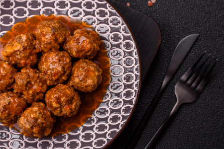 Meat, meatballs in tomato sauce, Italian food, beef or pork with salt and spices. Meatballs with tomatoes as a background for your designの写真素材