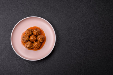 Meat, meatballs in tomato sauce, Italian food, beef or pork with salt and spices. Meatballs with tomatoes as a background for your designの写真素材