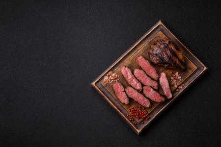 Grilled beef steak meat with salt and pepper. Beef steak grilled on a barbecue as a background for your designの写真素材