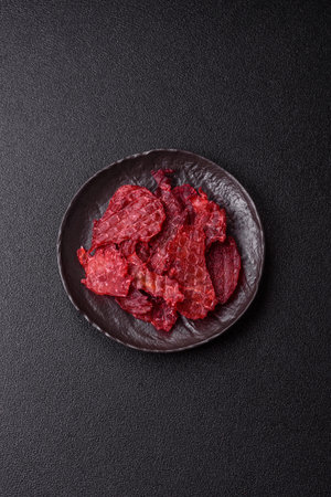Jerky or dried chicken and cherry snacks. Dehydrated, dried snacks for beer or for your petsの写真素材