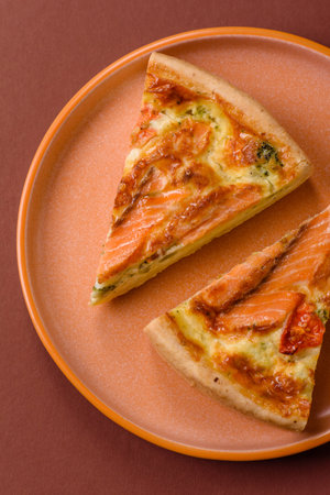 Quiche, salmon pie, broccoli, cheese. Quiche tart with fish and vegetables, cheese, salt and spices, healthy foodの写真素材