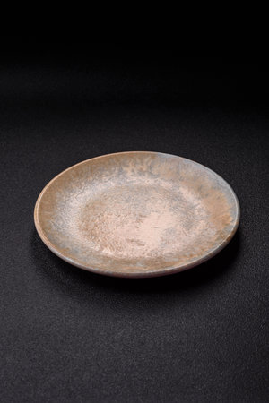 Empty round black plate for food, kitchen utensils on dining table. Empty plate on dark backgroundの写真素材