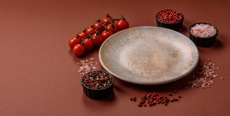 Empty round black plate for food, kitchen utensils on dining table. Empty plate on dark backgroundの写真素材