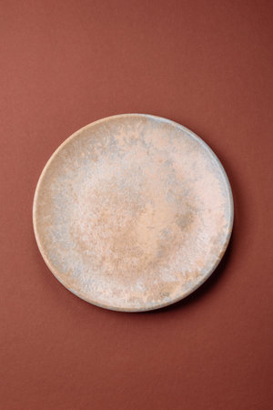 Empty round plate for food, kitchen utensils on dining table. Empty plate on dark backgroundの写真素材