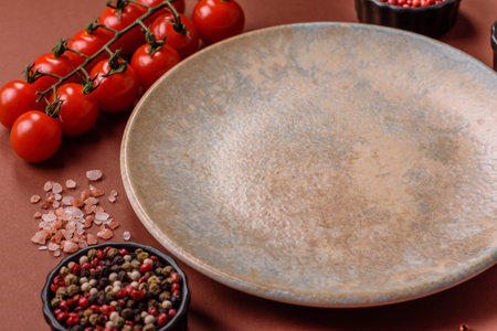 Empty round black plate for food, kitchen utensils on dining table. Empty plate on dark backgroundの写真素材