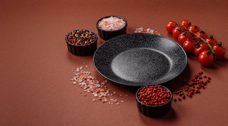 Empty round black plate for food, kitchen utensils on dining table. Empty plate on dark backgroundの写真素材
