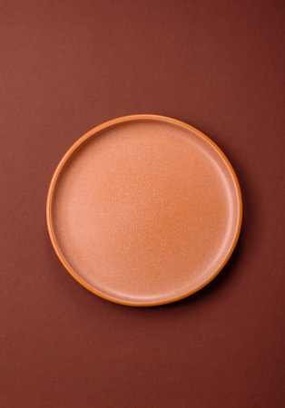Empty round plate for food, kitchen utensils on dining table. Empty plate on dark backgroundの写真素材