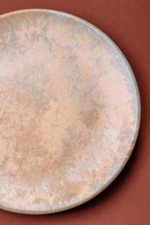 Empty round plate for food, kitchen utensils on dining table. Empty plate on dark backgroundの写真素材