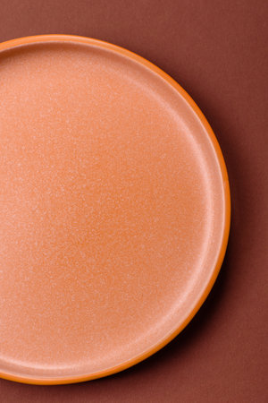Empty round ceramic plate on dark backgroundの写真素材