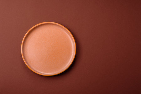 Empty round black plate for food, kitchen utensils on dining table. Empty plate on dark backgroundの写真素材