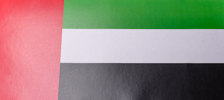 UAE flag in red, white, green and black colors as a symbol of independence. Flag of UAE as a background for your designの写真素材