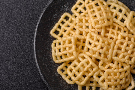 Lattice or wafer potato chips, crispy yellow snacks, takeaway food. Potato chips, junk foodの写真素材