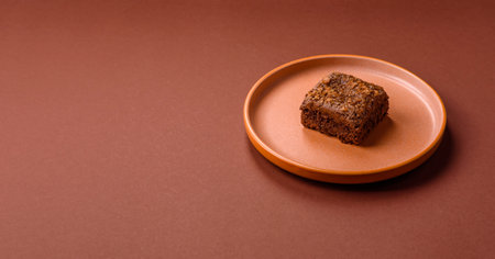 Chocolate brownie cake, food, sweet dessert with nuts rectangular shape. A slice of sweet chocolate brownie for the dinner tableの写真素材