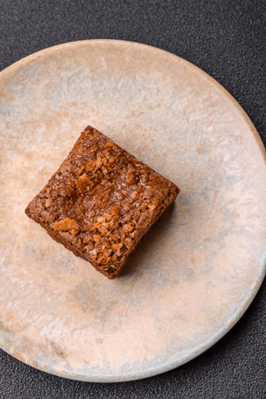 Chocolate brownie cake, food, sweet dessert with nuts rectangular shape. A slice of sweet chocolate brownie for the dinner tableの写真素材