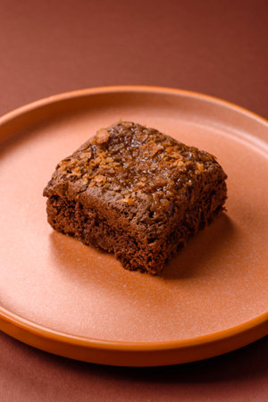 Chocolate brownie cake, food, sweet dessert with nuts rectangular shape. A slice of sweet chocolate brownie for the dinner tableの写真素材