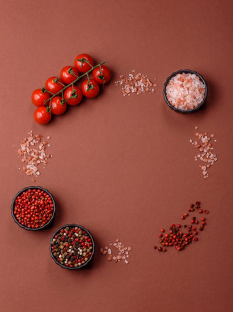 Ingredients for cooking cherry tomatoes, salt, spices and herbs on a dark concrete backgroundの写真素材
